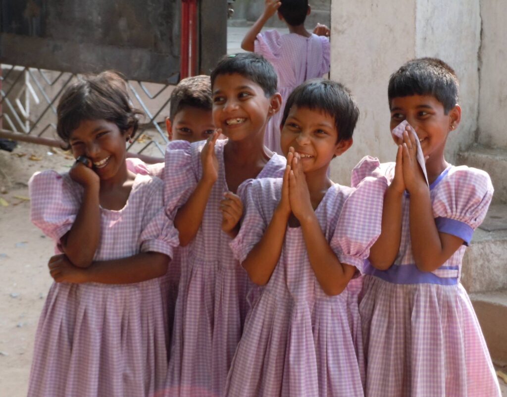 Children smiling in a community DNI serves